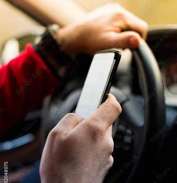 A person driving a car while texting about to cause a car wreck. Our car accident lawyer in College Station, TX can help you with your distracted driving car accident case.