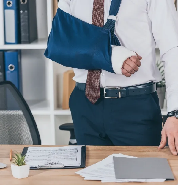A man standing at a desk with his arm in a cast. If a property owner's negligence has caused you or a loved one to be injured our experienced premises liability lawyers can help you navigate the legal process to seek compensation for your personal injury lawsuit.