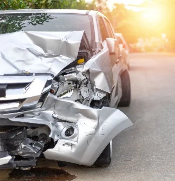 a car with a crushed front end after a distracted driving related auto accident. Our personal injury attorney in College Station has experience dealing with distracted driving legal cases.