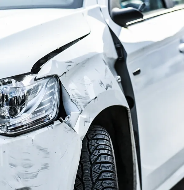 A car with damage to the front left side near the headlight from a car accident. Our auto accident lawyers provide guidance and legal counsel for those who have been in a wreck.
