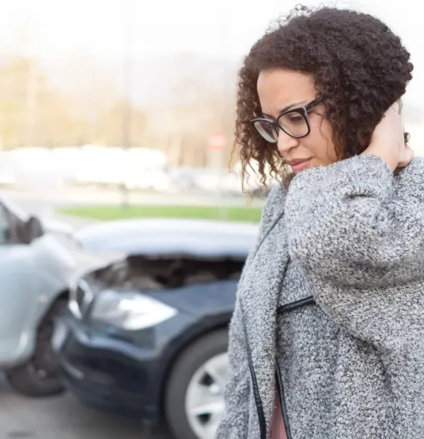 Woman holding her neck after a car accident needing to call a College Station personal injury attorney.
