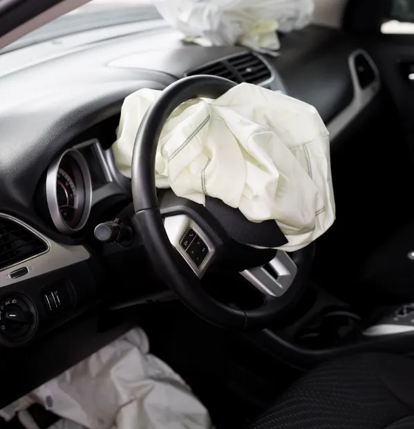 A deployed airbag in a car after an auto accident. When tragedy strikes, our personal injury lawyer for College Station and Bryan, TX can help.