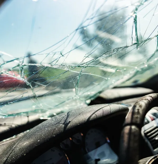 A shattered car window after a serious car accident. A Buffalo car accident lawyer can help obtain compensation.
