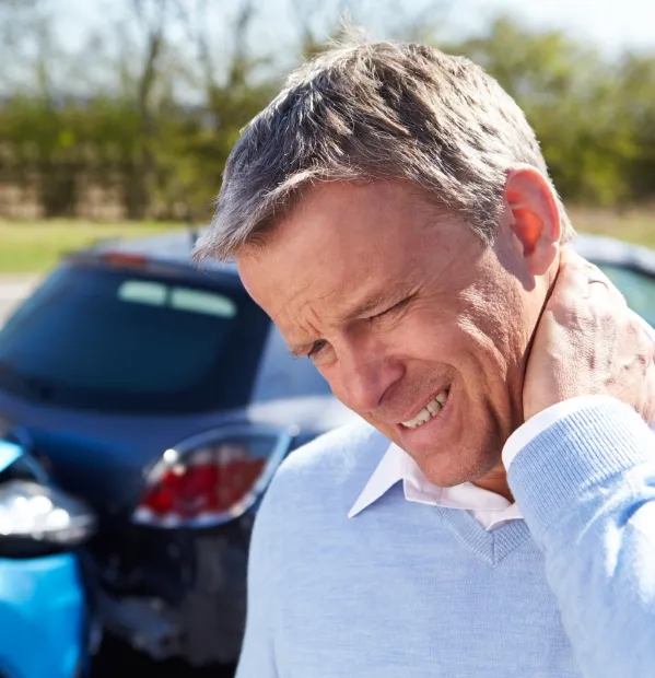 Man holding his neck in pain after a car accident. If you've suffered an injury after a car accident, our Bryan car accident lawyers are ready to fight for the compensation you deserve.