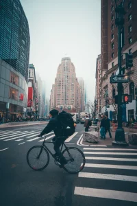 A cyclist biking in a city street.