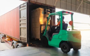 Commercial truck being loaded with a fork lift.
