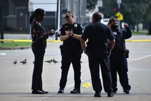 A group of police officers standing in the roadway preserving evidence.