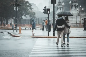 A couple crossing the street.