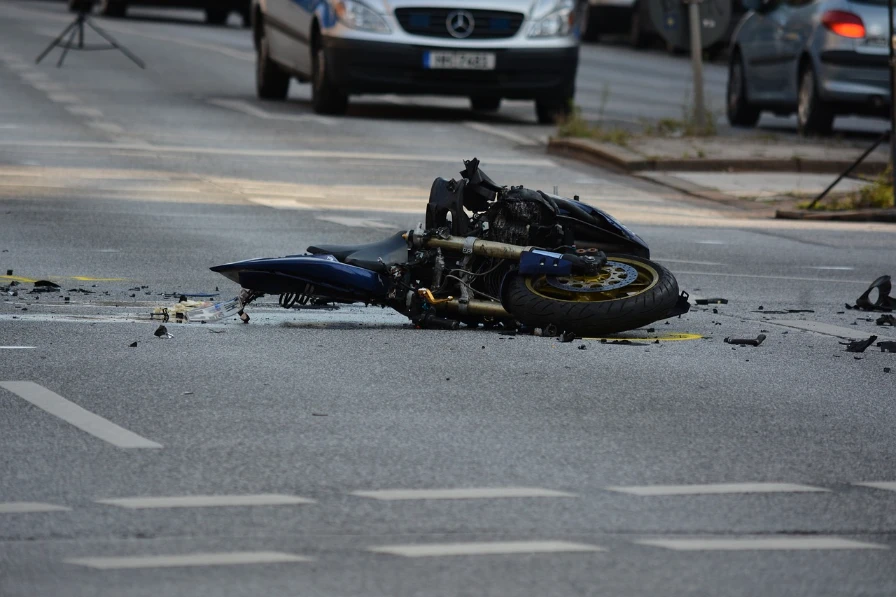 A motorcylce laying in the road after an accident.