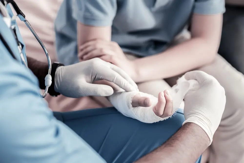 medical professional wrapping a wrist.