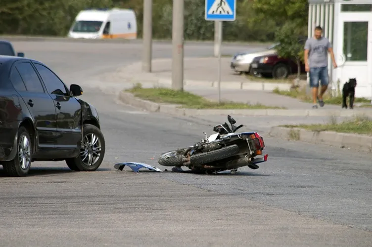 Crashed motorcyle in the middle of a road.